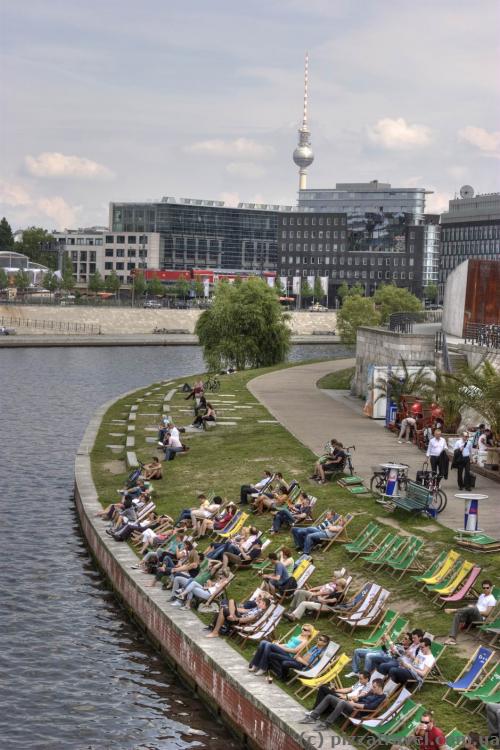 Berliners rest near the Spree river.